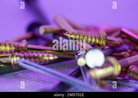 A colorful mix of nails and screws with eyelets and hoes Stock Photo