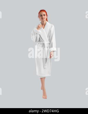 Girl posing in full length in a white plush robe - mockup of home clothes for design, branding, advertising. Isolated bathrobe template on the backgro Stock Photo