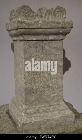 Funerary monument, shaped as a stone altar, and respective socle, of Caius Servilius Claranus. 2nd century AD. Inscription: 'Dedicated to Gods Manes. Caius Servilius Claranus, of 18 years, is buried here. May the earth be light on you!'. From the Roman ruins of Troia. Grândola, Setúbal district, Portugal. National Archaeology Museum. Lisbon, Portugal. Stock Photo