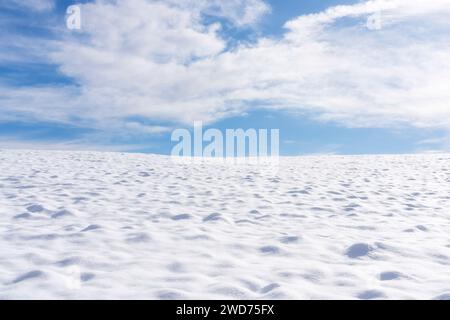 Abstract winter panorama with snowy wavy terrain and clear sky with some clouds. Tuscany region, Italy Stock Photo