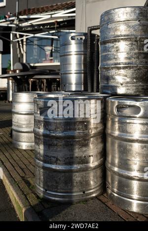 Stacked large 50 liter metal beer barrels on the terrace of a café Stock Photo