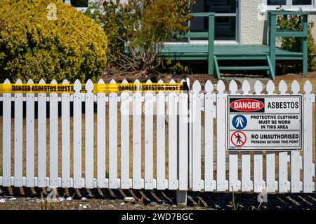 Warning signage about asbestos dust hazard outside a property in Motueka, Tasman region, Aotearoa / New Zealand. Stock Photo