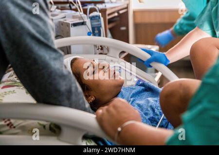 Mom breathes through contraction with washcloth on forehead Stock Photo