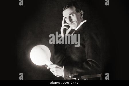 Portrait - Nikola Tesla carries a lamp for a few meters from the generator, but it continues to shine! Photo by Sarony, circa 1898 Stock Photo