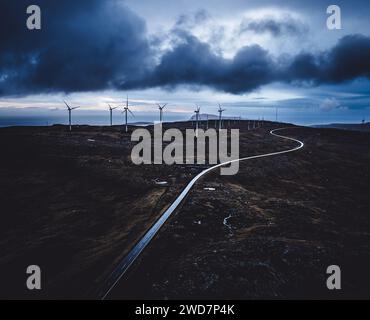 Windfarm and road over barren landscape, Faroe Islands. Stock Photo