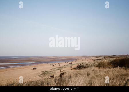 Beach Walkers in Hunstanton on a Sunny Winter Day Stock Photo