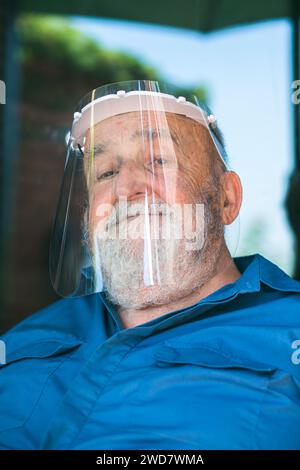 elderly man wearing a protective visor Stock Photo