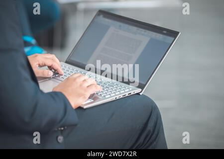 closeup of man using a laptop taking notes during a seminar presentation event Stock Photo