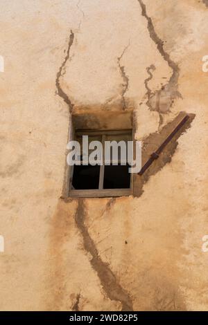 Broken window in cracked wall. Stock Photo