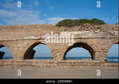 Stone arches and abutments of the Hadrianic aqueduct of Caesarea Maritima National Park along Israel's Mediterranean coast. Stock Photo