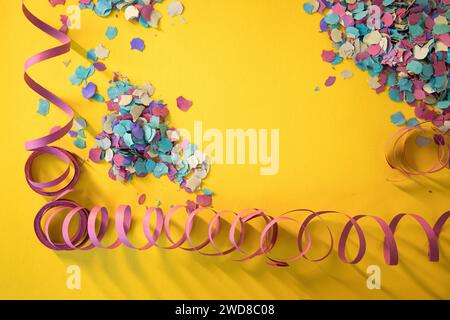 Symbolic image alluding to Carnival using streamers and confetti transmitting a lot of color typical of the festive season. Copy space. Stock Photo