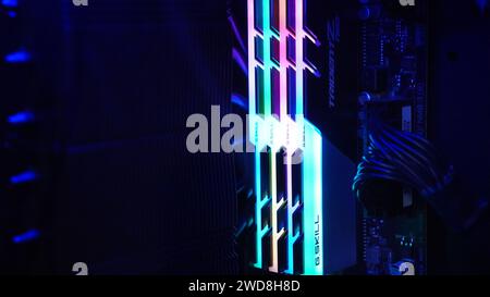 A motherboard with glowing in rainbow RAM memory, gaming-style Stock Photo