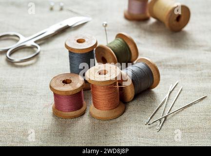 needles with sewing thread and scissors on a canvas Stock Photo