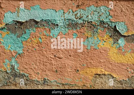 Detail of pastel colored flaking paint layers on old weathered wall, grunge backround Stock Photo
