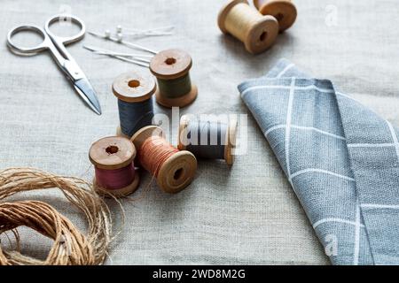 sewing thread with needles and scissors on a canvas Stock Photo