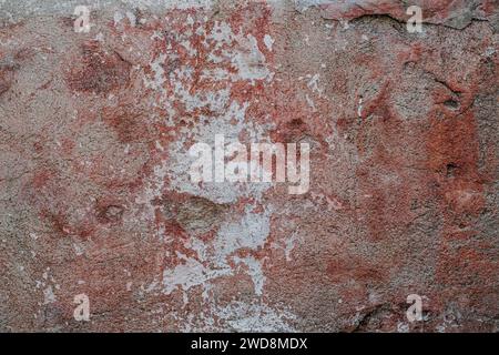 Old concrete wall texture with scraps of worn out paint, grunge background Stock Photo