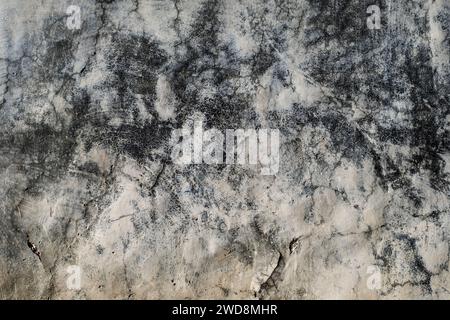 Detail of old cracked wall plaster with damp stains, grunge background Stock Photo