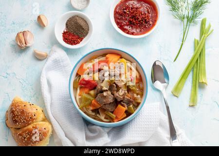 Uzbek food with noodles, vegetables and spices Lagman. Uyghur-style lagman with undercooked vegetables. Uzbek and Central Asia cuisine concept. Flatla Stock Photo