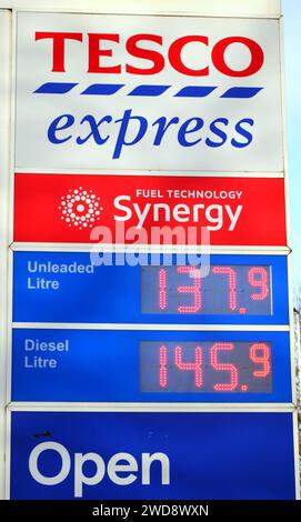 Tesco petrol price sign at a Tesco Express shop or store in Manchester, UK, offers unleaded at 137.9 pence and diesel at 145.9 pence. Petrol prices have fallen as oil came down in price. Stock Photo