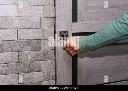 A man's hand opens the door. close-up Stock Photo