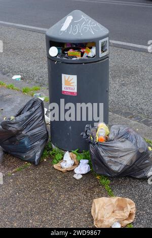 Waste bin and plastic bags full of rubbish. AMA (Municipal Environment Company) at Eur, Rome, Italy Stock Photo