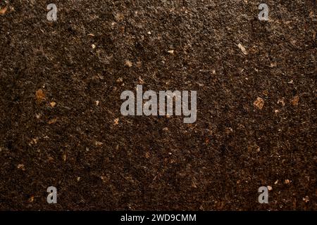 Macro detail of dark brown colored luxury artisan paper texture with natural fibres, recycled fine paper background Stock Photo
