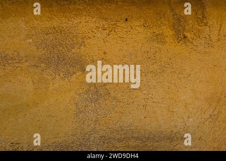 Detail of yellow ochre colored sand-faced plaster finish wall texture Stock Photo