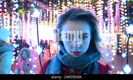 London, UK, 17th January 2024, Winter Lights at Canary Wharf opened for its 8th edition. Light installations are around the area for people to explore. It's free; it opened on the 17th till 27th January 2024. Julia a model from Norway was enjoying the lights on a very cold night, this art installation is called Submergence by Squidsoup., Andrew Lalchan Photography/Alamy Live News Stock Photo