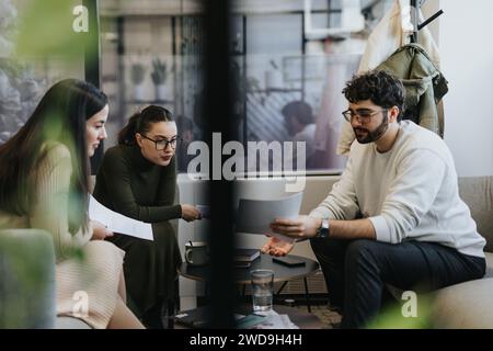 Successful business people collaborating on analyzing project statistics Stock Photo