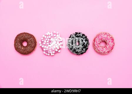 Delicious donut on color background. Mix of multicolored doughnuts, top view Stock Photo