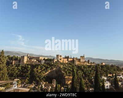 Panoramic view of the castle Alhambra in Granada, Andalusia, Spain, during sunset, from the Mirador de San Nicolas, golden hour, clear sky, sunlight Stock Photo