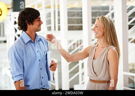 Smile, funny and a mentor laughing with her employee in the office together for training or coaching. Collaboration, management and a happy business Stock Photo
