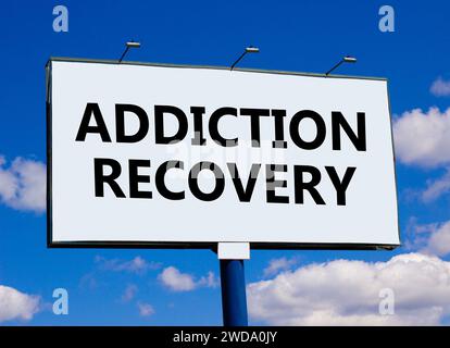 Addiction recovery symbol. Concept words Addiction recovery on beautiful white billboard. Beautiful blue sky white cloud background. Psychology addict Stock Photo