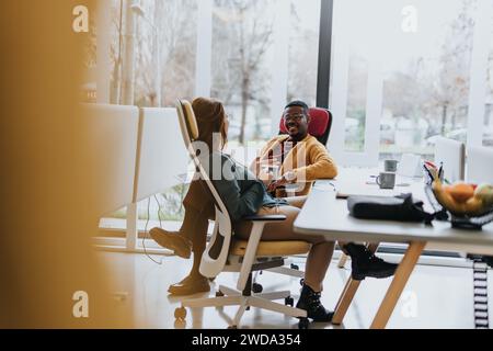 A diverse team collaborating on a project in an innovative office, discussing business strategies and working together towards success. Stock Photo