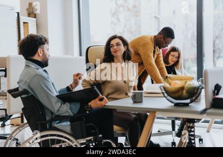 A group of multicultural coworkers collaborating in a creative office. Stock Photo