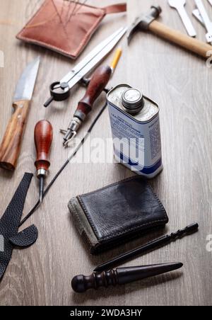 Concept of handcrafted leather goods. The moment of rubbing the side of the wallet. Handcrafted tools. Genuine leather design Stock Photo
