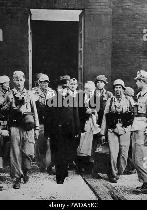 Overthrown in July 1943, the Italian dictator Mussolini was imprisoned in the Gran Sassa Hotel in the Abruzzo Mountains He can be seen walking from captivity on the 12th September German troops released him during the Second World War. Stock Photo