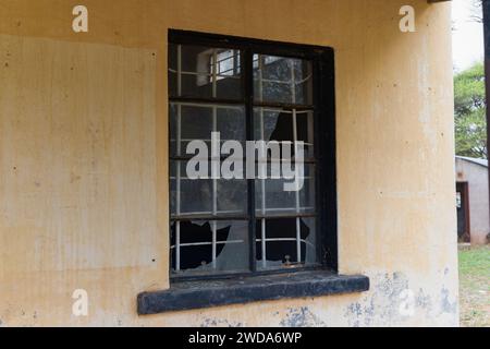 broken window with burglar bars on an old building, colonial architecture vintage in a village in Botswana, design elements and textures Stock Photo