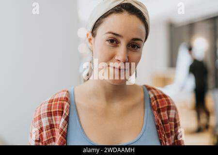 Portrait of female hipster employees with slight smile on her face. Stock Photo