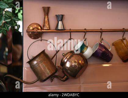 Copper pots hanging on the wall vintage style setup Stock Photo