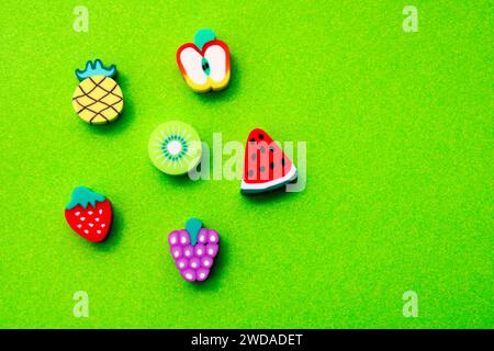 Various figures shaped like fruits on a green background Stock Photo
