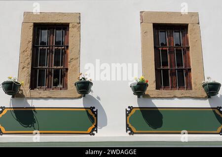 254 Barred wood windows on white wall, Ottoman building in the Old Bazaar, Central Square area -Pazari i Vjeter, Sheshi Iliria-. Korca-Albania. Stock Photo