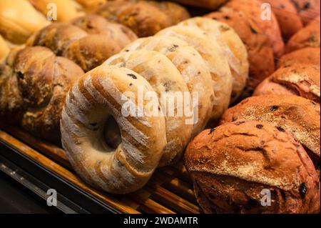 Freshly baked bread displayed in a basket for sale at a local bakery Stock Photo