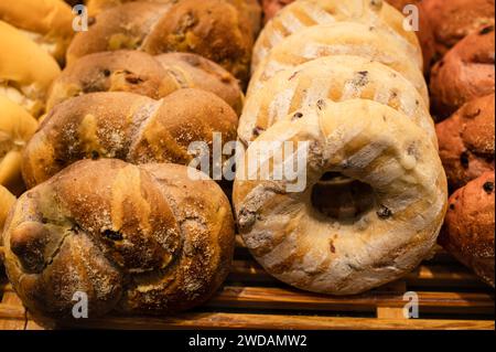 Assorted breads neatly arranged on a wooden tray Stock Photo