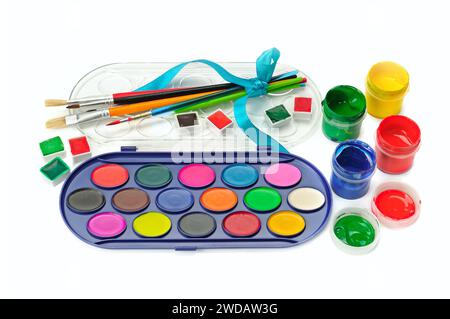Watercolor paints, gouaches and brushes isolated on white background. Stock Photo