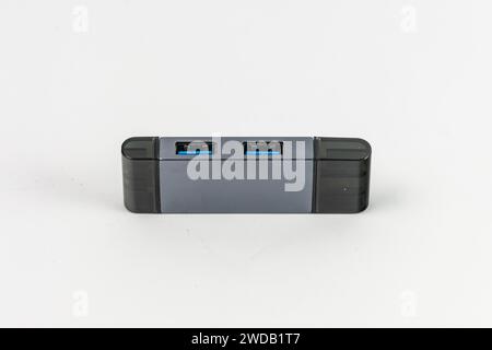 Small USB hub with two ports USB-A and SD and microSD cards slots and is compatible with USB-C Stock Photo