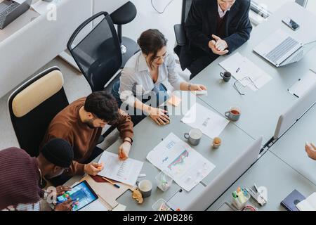 Multicultural professionals collaborating around a conference table ...