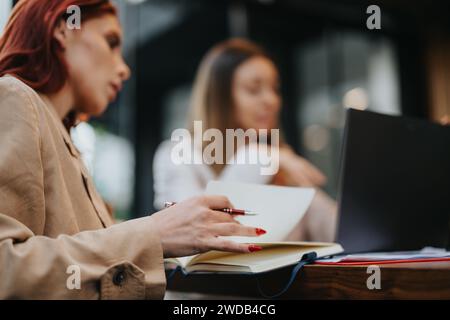 Young, Female, Business People Discussing Marketing Strategy at a Coffee Bar in the City. Stock Photo