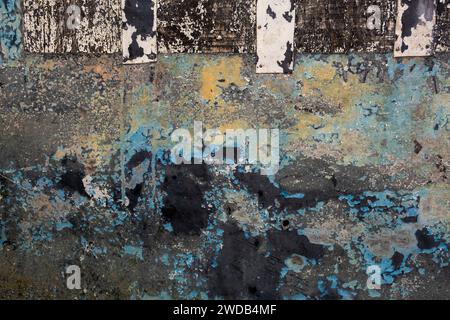 Detail of old metallic panel with scraps of flaking paint layers, grunge background Stock Photo