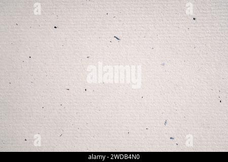 Recycled artisan paper mottled with natural fibres, luxury eco paper background Stock Photo
